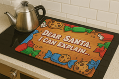 Kitchen mat with 'Dear Santa, I can explain' text and candy graphics on a stove.