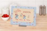 Personalized hot chocolate station sign with cartoon characters on a kitchen counter.