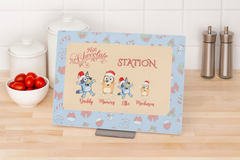 Personalized hot chocolate station sign with cartoon characters on a kitchen counter.
