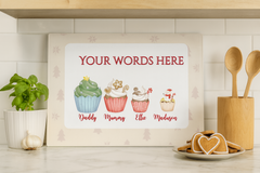 Decorative sign with cartoon cupcakes and placeholder text in a kitchen setting