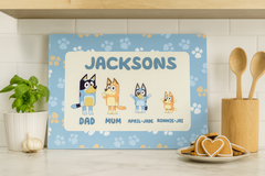 Personalized children's nameplate with cartoon characters on a kitchen counter.