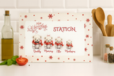 Hot chocolate station sign with teddy bears and personalized names on a kitchen counter.