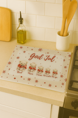 Christmas-themed placemat with teddy bears and text on a kitchen counter.