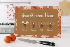 Personalized cutting board with family members' names on a kitchen counter.