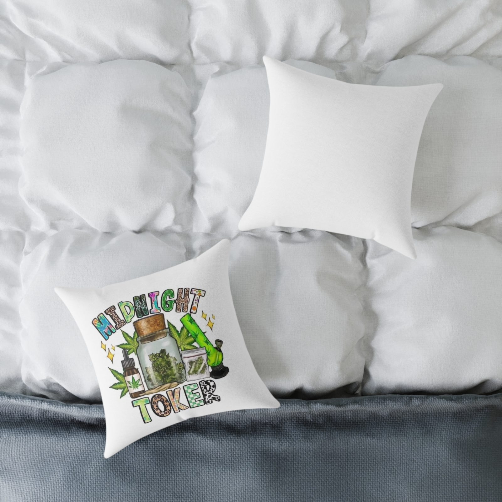“Midnight Toker pillow with weed illustrations placed on a white comforter”
