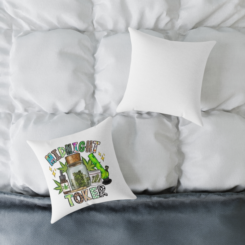 “Midnight Toker pillow with weed illustrations placed on a white comforter”
