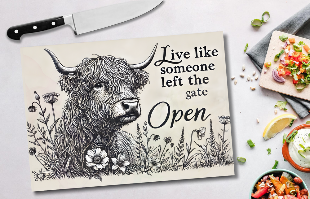 Chopping board with a highland cow illustration and text on a table with food.