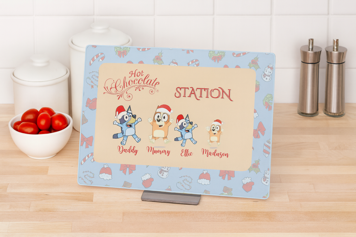 Personalized hot chocolate station sign with cartoon characters on a kitchen counter.
