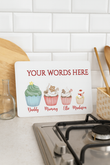 Personalized kitchen sign with cupcake illustrations on a white countertop.