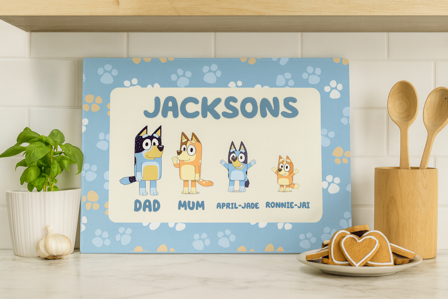 Personalized children's nameplate with cartoon characters on a kitchen counter.