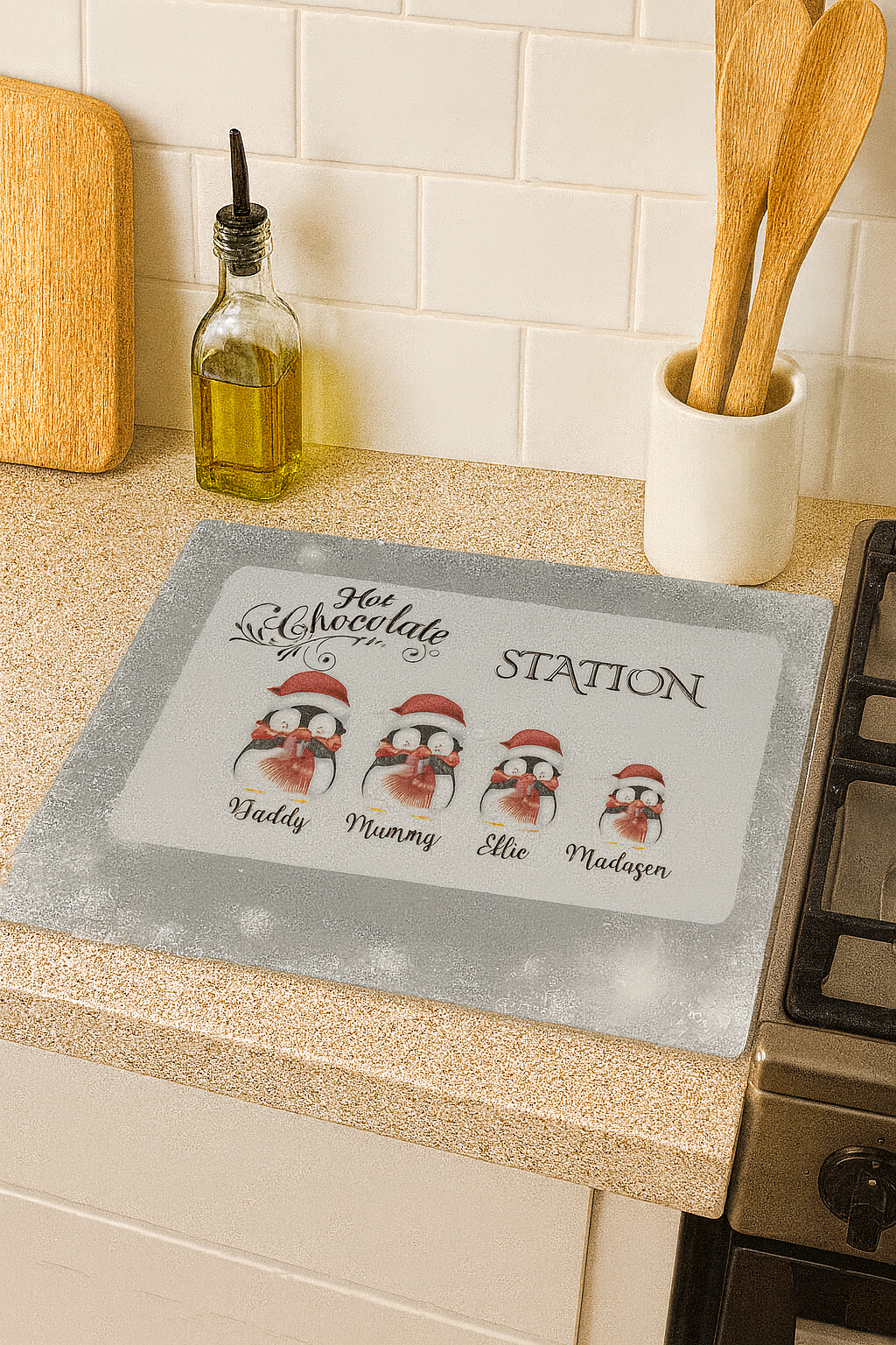 Kitchen countertop with a personalized penguin-themed placemat featuring family names.