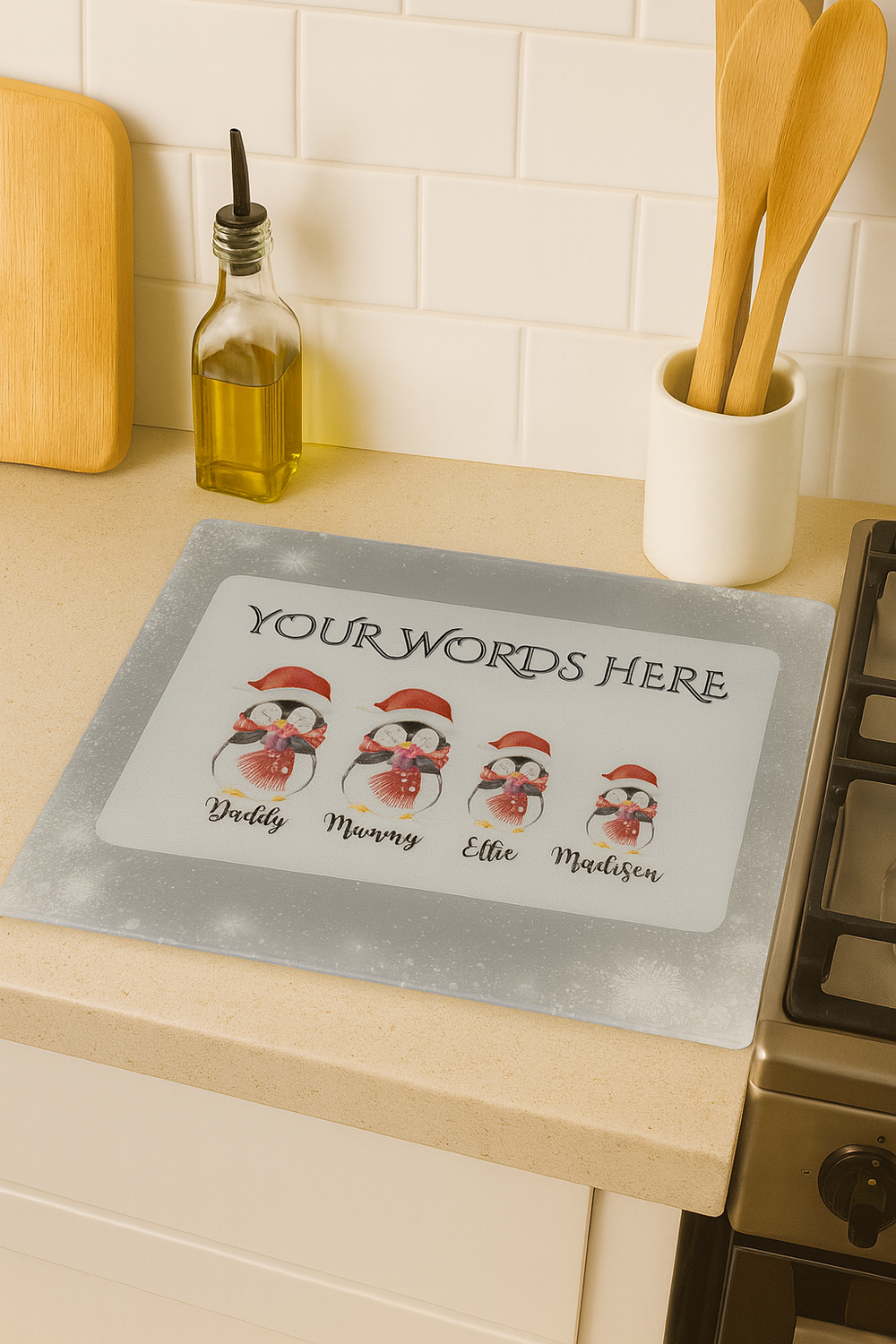 Personalized penguin family mat on a kitchen counter with text 'Your Words Here'.