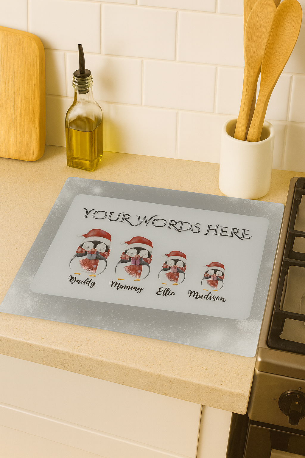 Personalized penguin family mat with customizable names on a kitchen counter.