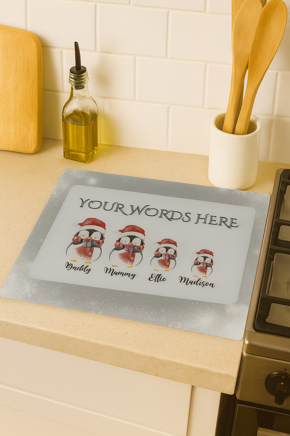 Personalized penguin family mat with customizable names on a kitchen counter.