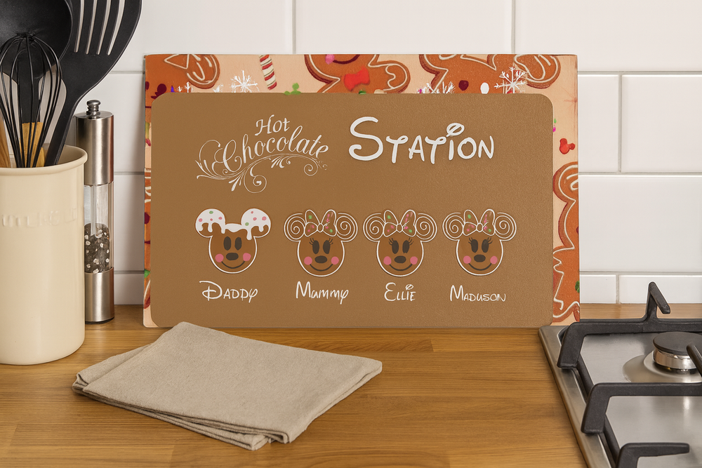 Hot chocolate station sign with cartoon faces on a kitchen counter.