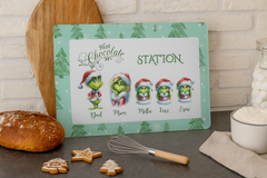 Christmas-themed hot chocolate station sign with cartoon characters on a kitchen counter.
