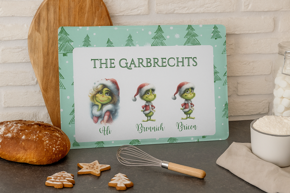Personalized Christmas sign with Grinch characters and family names on a kitchen counter.