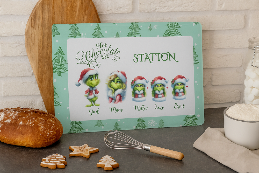 Christmas-themed hot chocolate station sign with cartoon characters on a kitchen counter.