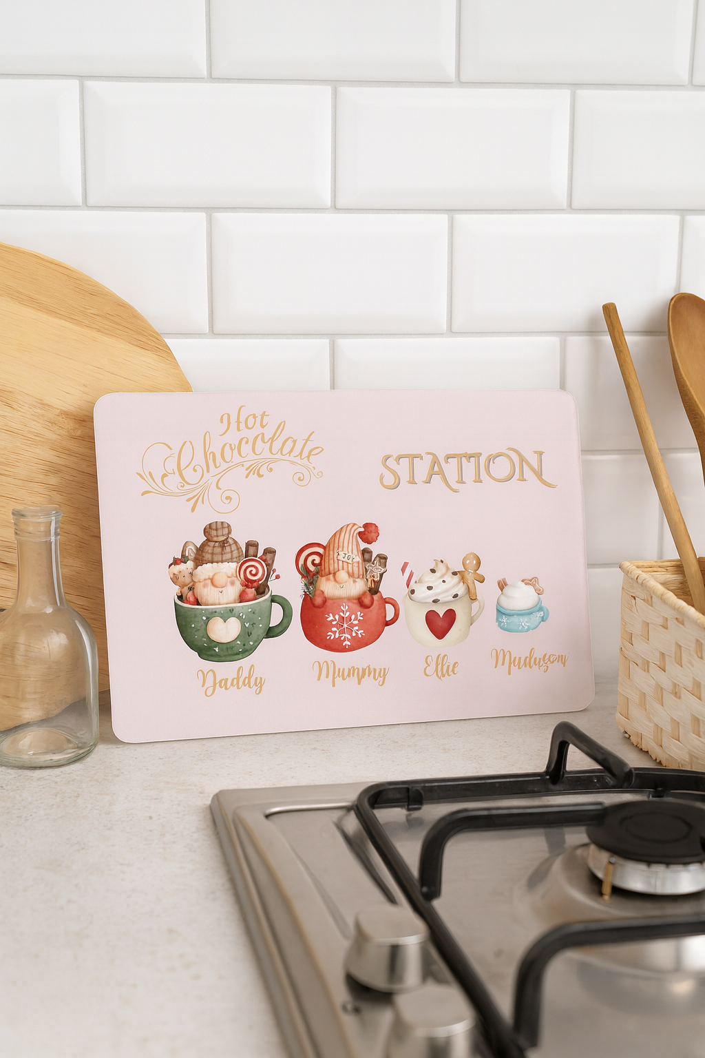 Decorative sign for a hot chocolate station on a kitchen counter with a white tiled wall background.