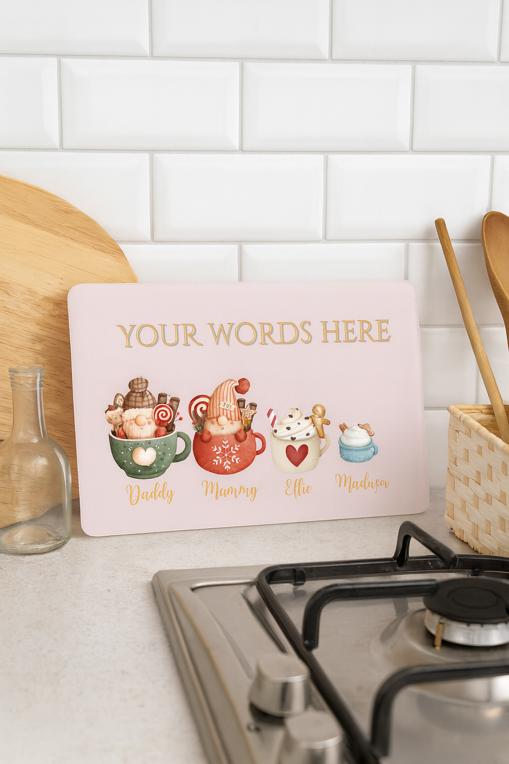 Decorative sign with cartoon characters and text space on a kitchen counter.